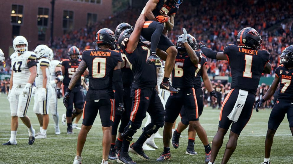 Oregon State wide receiver Anthony Gould is lifted by offensive lineman Jake Levengood after scoring a touchdown against Montana State during the first half of an NCAA college football game in Portland, Ore., Saturday, Sept. 17, 2022. (AP Photo/Craig