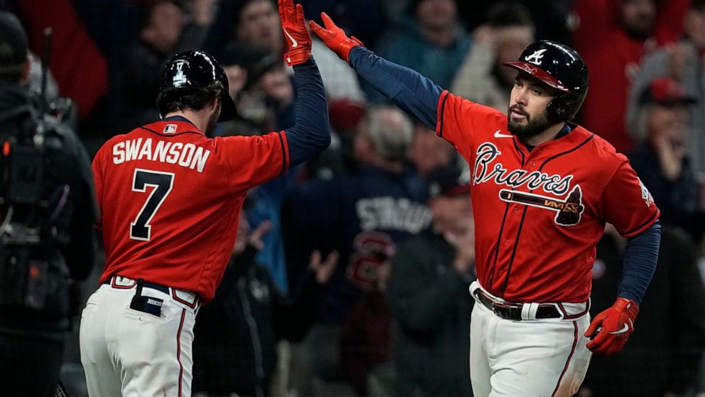Atlanta Braves' Travis d'Arnaud celebrates his home run with Dansby Swanson during the eighth inning in Game 3 of baseball's World Series between the Houston Astros and the Atlanta Braves Friday, Oct. 29, 2021, in Atlanta. (AP Photo/Brynn Anderson)