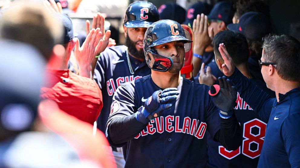Cleveland Guardians' Andres Gimenez is greeted by teammates after hitting a three-run home run against Baltimore Orioles starting pitcher Dean Kremer during the first inning of a baseball game, Sunday, June 5, 2022, in Baltimore. (AP Photo/Terrance W