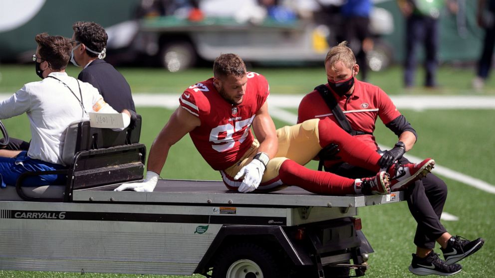 San Francisco 49ers defensive end Nick Bosa (97) is driven off the field after being injured during the first half of an NFL football game against the New York Jets Sunday, Sept. 20, 2020, in East Rutherford, N.J. After losing four players to knee in