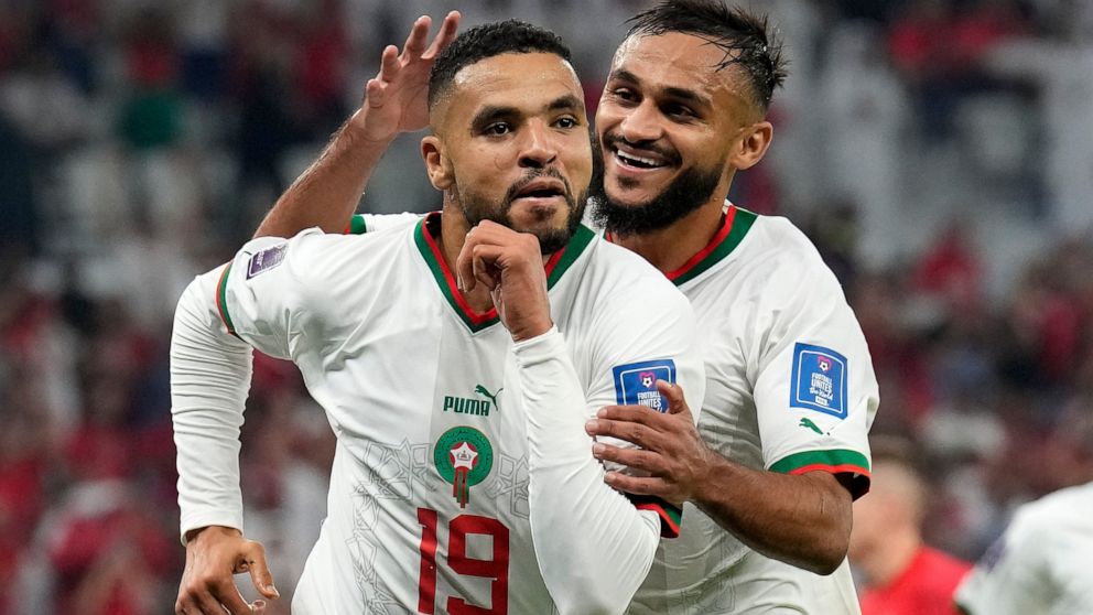 Morocco's Youssef En-Nesyri , left, celebrates beside Morocco's Sofiane Boufal, right, after he scored his side's second goal during the World Cup group F soccer match between Canada and Morocco at the Al Thumama Stadium in Doha , Qatar, Thursday, De