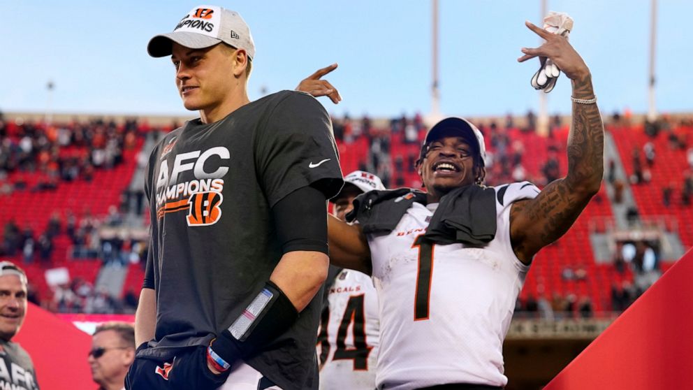 Cincinnati Bengals quarterback Joe Burrow, left, and wide receiver Ja'Marr Chase (1) celebrate after the AFC championship NFL football game against the Kansas City Chiefs, Sunday, Jan. 30, 2022, in Kansas City, Mo. The Bengals won 27-24 in overtime. 