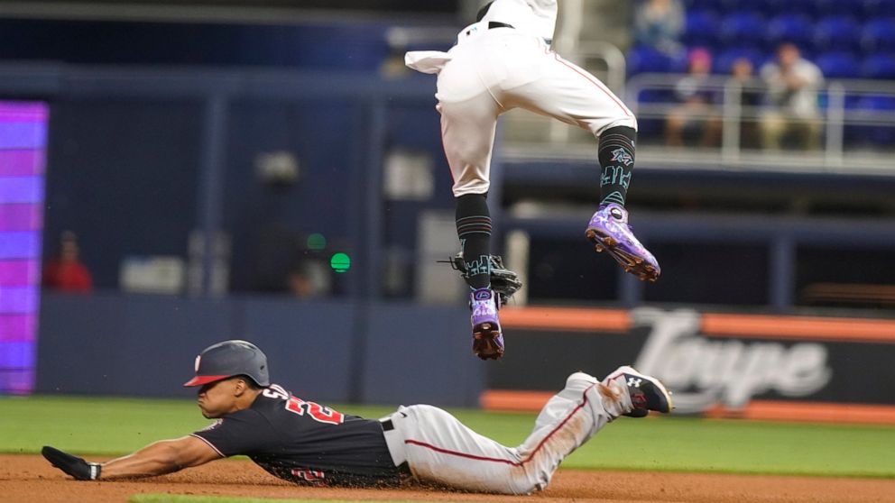 Washington Nationals Juan Soto (22) steals second base as Miami Marlins second baseman Jazz Chisholm Jr. (2) is late with the tag during the first inning of a baseball game, Tuesday, June 7, 2022, in Miami. (AP Photo/Marta Lavandier)