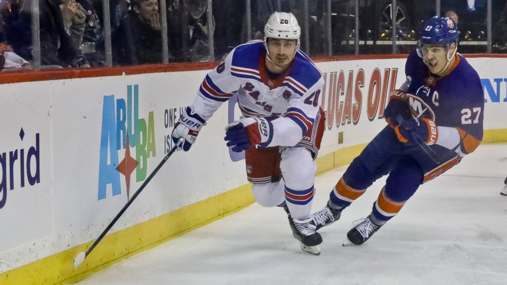 New York Rangers' Chris Kreider, left, and New York Islanders' Anders Lee chase the puck during an NHL hockey game, Saturday, Jan. 12, 2019, at Barclays Center in New York. (AP Photo/Bebeto Matthews)