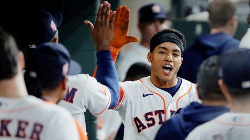 Houston Astros' Jeremy Pena, right, collects high-fives in the dugout after his home run against the Detroit Tigers during the fifth inning of a baseball game Thursday, May 5, 2022, in Houston. (AP Photo/Michael Wyke)