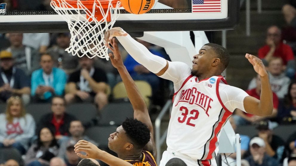 Ohio State's E.J. Liddell (32) blocks a shot by Loyola Chicago's Chris Knight during the first half of a college basketball game in the first round of the NCAA tournament, Friday, March 18, 2022, in Pittsburgh. (AP Photo/Keith Srakocic)