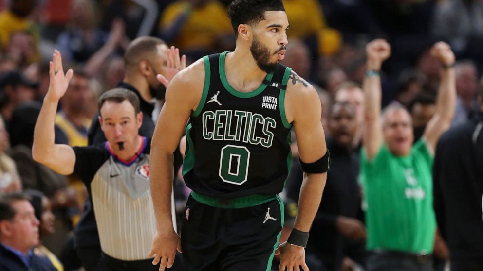 Boston Celtics forward Jayson Tatum (0) reacts after scoring against the Golden State Warriors during the second half of Game 5 of basketball's NBA Finals in San Francisco, Monday, June 13, 2022. (AP Photo/Jed Jacobsohn)