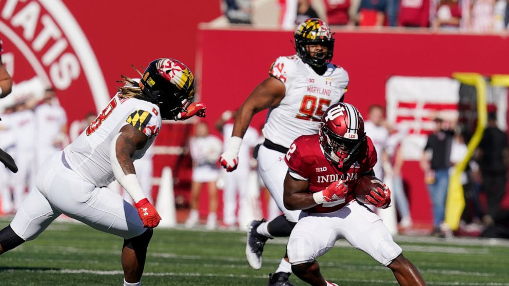Maryland's VanDarius Cowan (8) moves in to tackle Indiana's Shaun Shivers (2) during the first half of an NCAA college football game, Saturday, Oct. 15, 2022, in Bloomington, Ind. (AP Photo/Darron Cummings)