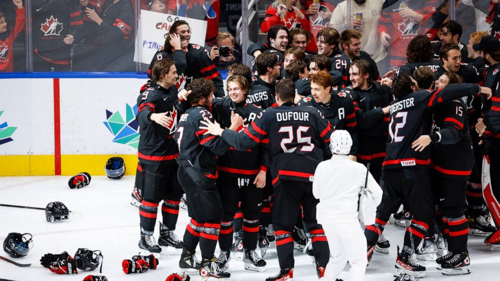 Canada celebrates defeating Finland during overtime in the gold medal game at the world junior hockey championship, Saturday, Aug. 20, 2022 in Edmonton, Alberta. (Jeff McIntosh/The Canadian Press via AP)