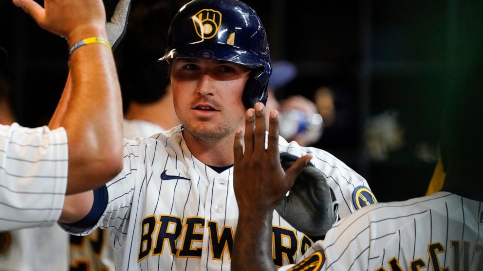 Milwaukee Brewers' Hunter Renfroe is congratulated after hitting a home run during the fifth inning of a baseball game against the Chicago Cubs Friday, April 29, 2022, in Milwaukee. (AP Photo/Morry Gash)