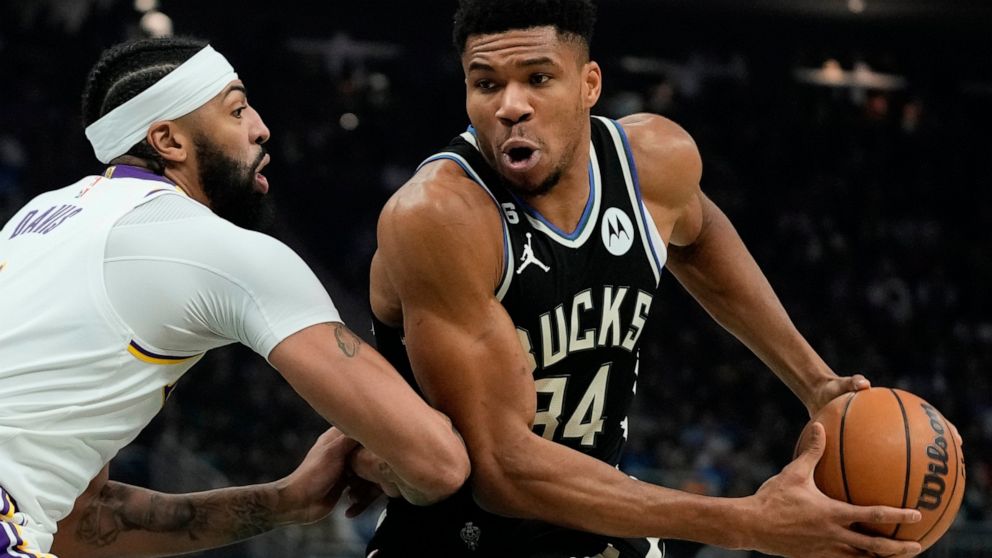 Milwaukee Bucks' Giannis Antetokounmpo drives past Los Angeles Lakers' Anthony Davis during the first half of an NBA basketball game Friday, Dec. 2, 2022, in Milwaukee. (AP Photo/Morry Gash)