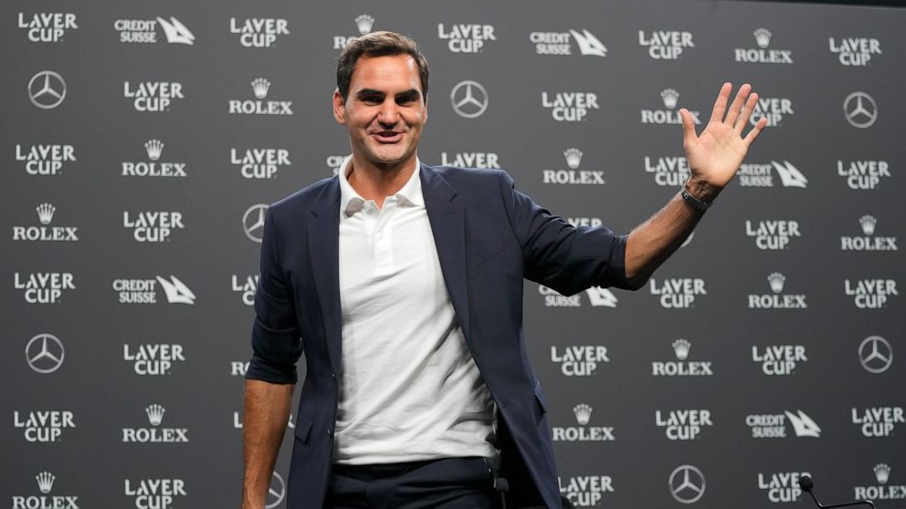 Switzerland's Roger Federer waves during a media conference ahead of the Laver Cup tennis tournament at the O2 in London, Wednesday, Sept. 21, 2022. Federer will meet with the media Wednesday to discuss walking away from the game at age 41 after 20 G