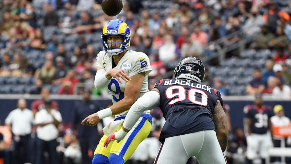 Los Angeles Rams quarterback Matthew Stafford (9) throws as he is pressured by Houston Texans defensive tackle Ross Blacklock (90) during the first half of an NFL football game, Sunday, Oct. 31, 2021, in Houston. (AP Photo/Justin Rex )