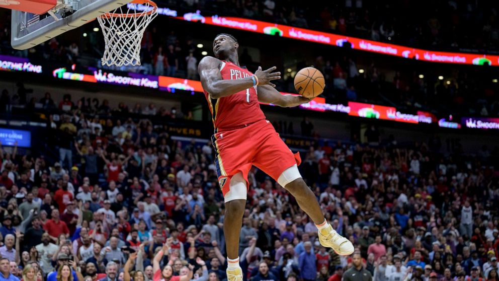 New Orleans Pelicans forward Zion Williamson (1) goes up to dunk against the Phoenix Suns in the second half of an NBA basketball game in New Orleans, Friday, Dec. 9, 2022. (AP Photo/Matthew Hinton)