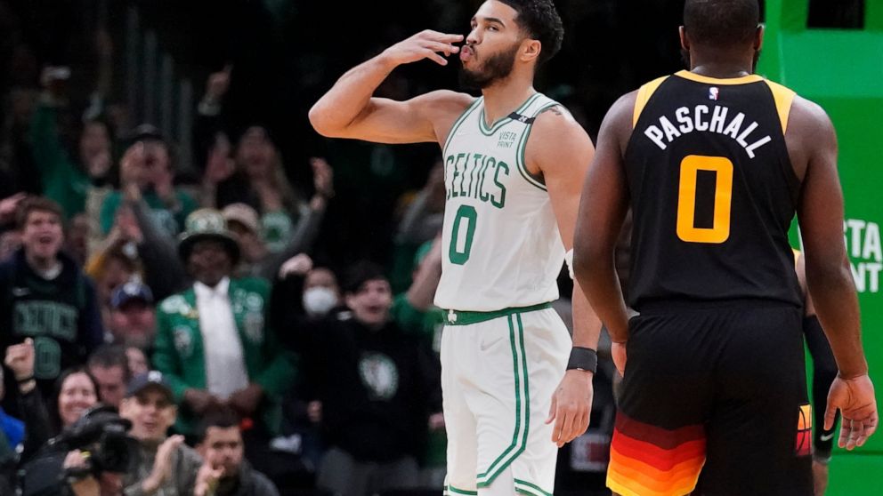 Boston Celtics forward Jayson Tatum (0) blows a kiss to fans after hitting a 3-pointer against the Utah Jazz during the first half of an NBA basketball game Wednesday, March 23, 2022, in Boston. (AP Photo/Charles Krupa)