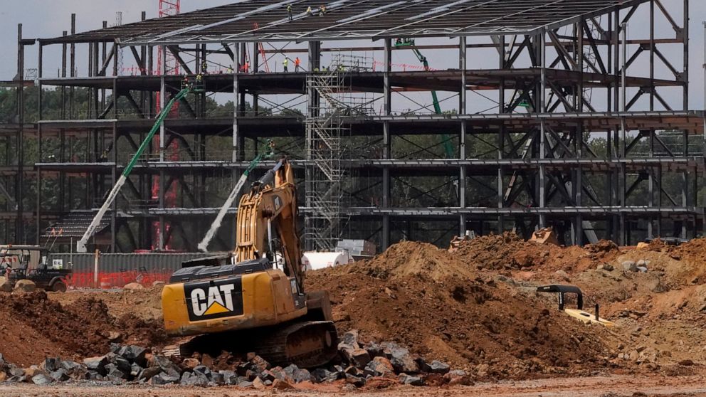 FILE - Construction personnel work on the Carolina Panthers' practice facility Tuesday, Aug. 24, 2021, in Rock Hill, S.C. Panthers owner David Tepper’s real estate company has promised to pay more $82 million to creditors over an abandoned practice f