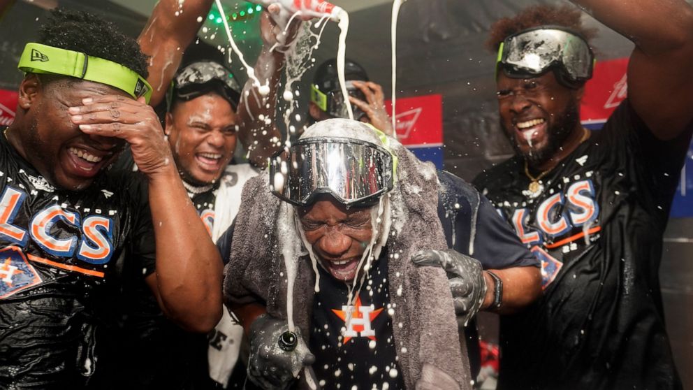 Houston Astros manager Dusty Baker Jr., center, celebrates with pitcher Hector Neris, left, and pitcher Cristian Javier, right, after defeating the Seattle Mariners in Game 3 of an American League Division Series baseball game Saturday, Oct. 15, 2022
