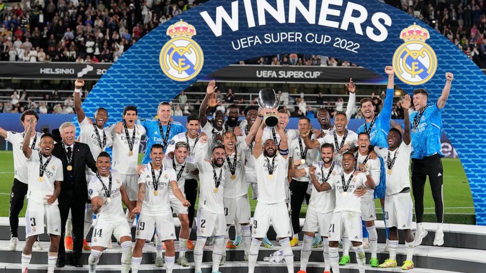 Real Madrid's Karim Benzema lifts the trophy after winning the UEFA Super Cup final soccer match between Real Madrid and Eintracht Frankfurt at Helsinki's Olympic Stadium, Finland, Wednesday, Aug. 10, 2022. Real Madrid won 2-0. (AP Photo/Antonio Calanni)