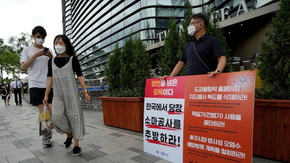 A protester stands to oppose South Korean President Moon Jae-in's possible visit to Japan in front of a building which houses Japanese embassy in Seoul, South Korea, Monday, July 19, 2021. Moon has decided not to visit Japan for the Tokyo Summer Olym