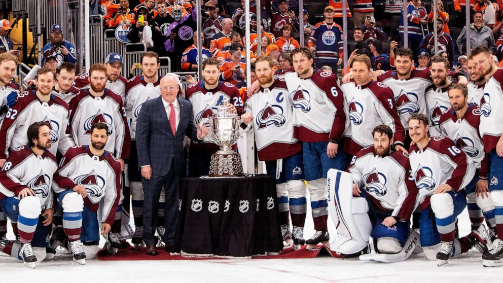 Colorado Avalanche players stand with the Campbell Conference Bowl and Deputy Commissioner Bill Daley after defeating the Edmonton Oilers during overtime NHL hockey conference finals action in Edmonton, Alberta, on Monday, June 6, 2022. (Jason Franso