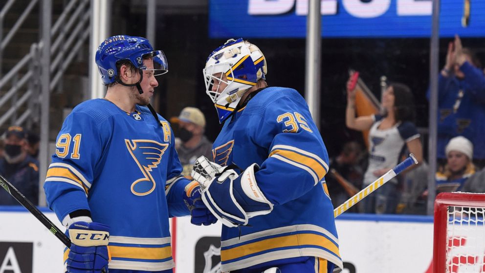 St. Louis Blues right wing Vladimir Tarasenko (91) and goaltender Ville Husso (35) celebrate the team's victory over the Chicago Blackhawks in an NHL hockey game Saturday, Feb. 12, 2022, in St. Louis. (AP Photo/Joe Puetz)