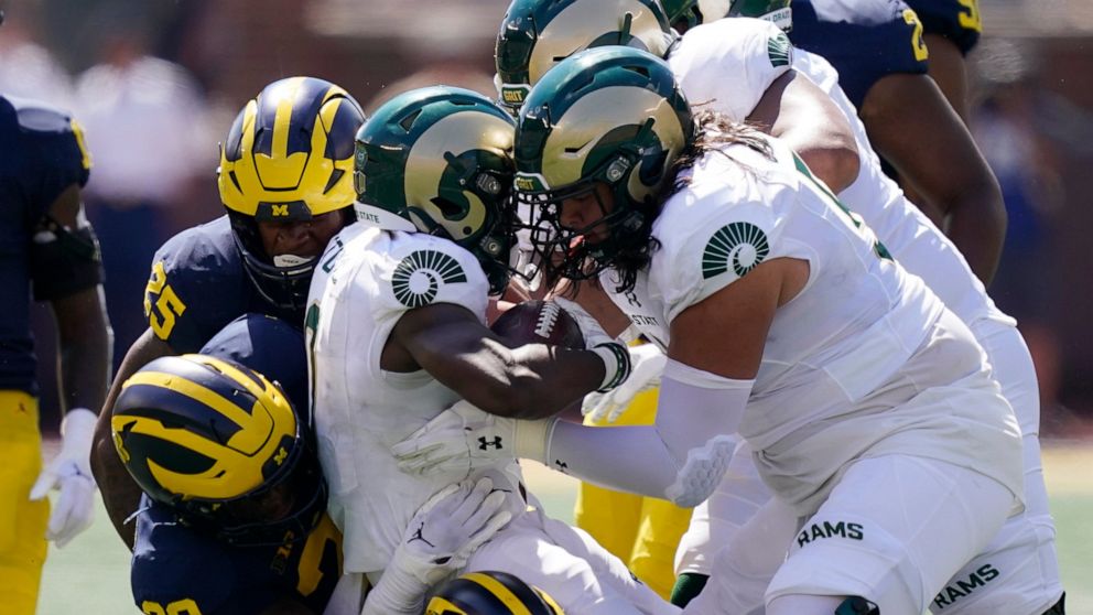 Colorado State wide receiver Melquan Stovall is tackled by the Michigan defense during the first half of an NCAA college football game, Saturday, Sept. 3, 2022, in Ann Arbor, Mich. (AP Photo/Carlos Osorio)