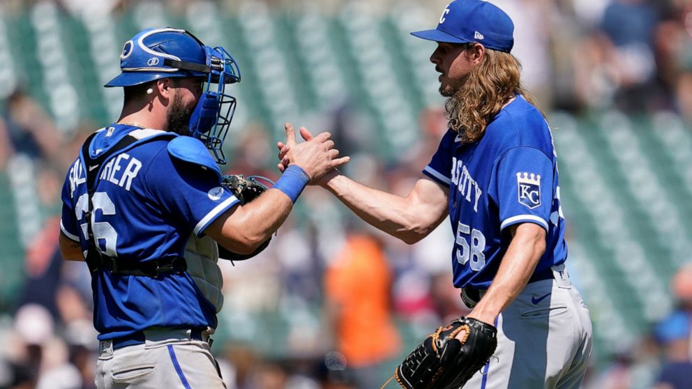Kansas City Royals catcher Cam Gallagher (36) and relief pitcher Scott Barlow (58) celebrate after the final out in the ninth inning of a baseball game against the Detroit Tigers in Detroit, Sunday, July 3, 2022. (AP Photo/Paul Sancya)