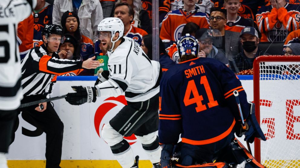 Los Angeles Kings center Anze Kopitar, left, celebrates his team's winning goal as Edmonton Oilers goalie Mike Smith looks on during overtime in Game 5 of an NHL hockey Stanley Cup first-round playoff series, Tuesday, May 10, 2022 in Edmonton, Albert