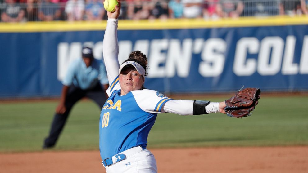 UCLA's Rachel Garcia pitches against Oklahoma in the first inning of the first game of the best-of-three championship series in the NCAA softball Women's College World Series in Oklahoma City, Monday, June 3, 2019. (AP Photo/Alonzo Adams)