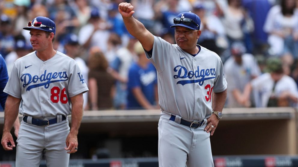 Los Angeles Dodgers manager Dave Roberts gestures to the crowd after the team defeated the San Diego Padres in a baseball game, Sunday, Sept. 11, 2022, in San Diego. (AP Photo/Derrick Tuskan)