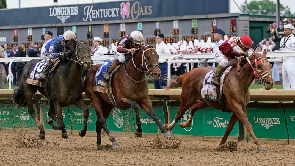 Rich Strike (21), with Sonny Leon aboard, leads Epicenter (3), with Joel Rosario aboard, and Zandon (10), with Flavien Prat aboard, down the straightaway to win the 148th running of the Kentucky Derby horse race at Churchill Downs Saturday, May 7, 20