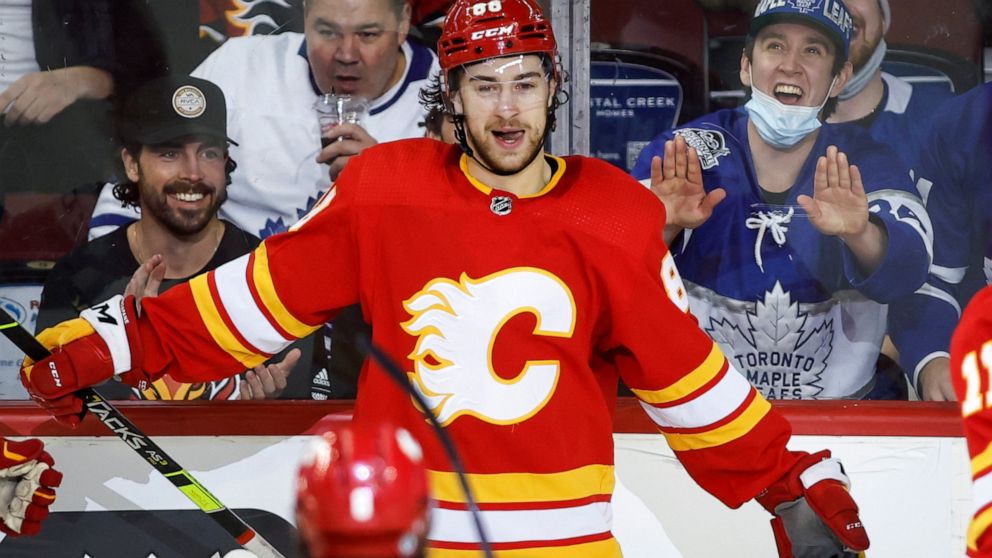 Calgary Flames' Andrew Mangiapane celebrates his goal against the Toronto Maple Leafs during the second period of an NHL hockey game Thursday, Feb. 10, 2022, in Calgary, Alberta. (Jeff McIntosh/The Canadian Press via AP)