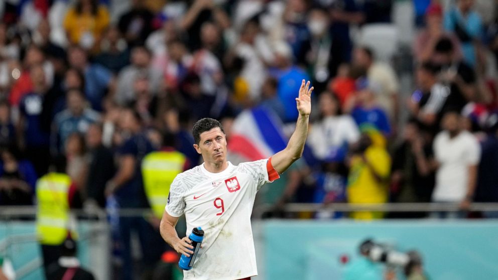 Poland's Robert Lewandowski waves after the World Cup round of 16 soccer match between France and Poland, at the Al Thumama Stadium in Doha, Qatar, Sunday, Dec. 4, 2022. (AP Photo/Natacha Pisarenko)