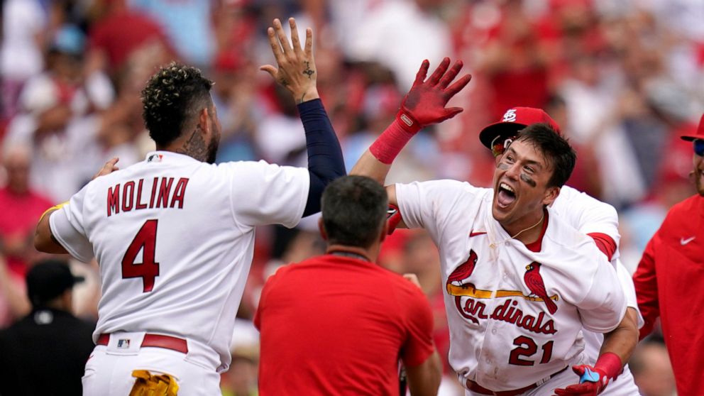 St. Louis Cardinals' Lars Nootbaar (21) is congratulated by teammate Yadier Molina (4) after hitting a walk-off single during the ninth inning to defeat the Chicago Cubs 4-3 in the first game of a baseball doubleheader Thursday, Aug. 4, 2022, in St. 