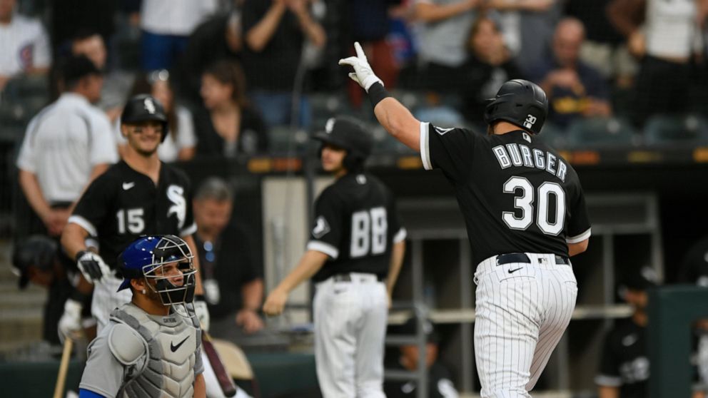 Chicago White Sox's Jake Burger (30) celebrates at home plate after hitting a solo home run during the fifth inning of a baseball game against the Chicago Cubs at Guaranteed Rate Field, Saturday, May 28, 2022, in Chicago. (AP Photo/Paul Beaty)