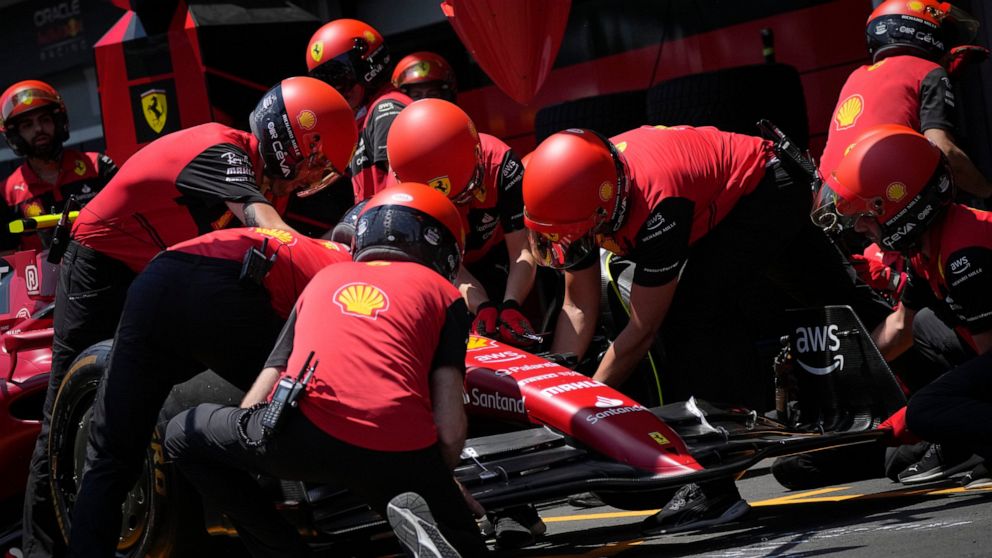 Technicians work on the car of Ferrari driver Charles Leclerc in the team garage at the Baku circuit, in Baku, Azerbaijan, Thursday, June 9, 2022. The Formula One Grand Prix will be held on Sunday. (AP Photo/Sergei Grits)