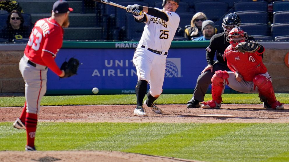 Pittsburgh Pirates' Yoshi Tsutsugo (25) drives in a run with a fielder's choice off Washington Nationals relief pitcher Sean Doolittle (63) during the seventh inning of a baseball game in Pittsburgh, Sunday, April 17, 2022. Catching is Riley Adams. (