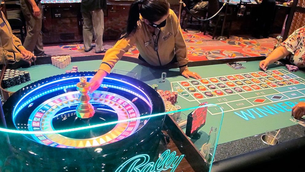 This June 23, 2021 photo shows a dealer conducting a game of roulette at Bally's casino in Atlantic City, N.J. Figures released Nov. 9, 2021 from the American Gaming Association show the nation's commercial casinos won nearly $14 billion in the third