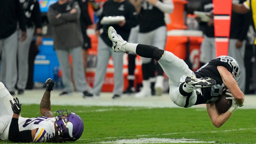 Las Vegas Raiders tight end Jesper Horsted is tackled by Minnesota Vikings cornerback Parry Nickerson during the second half of an NFL preseason football game, Sunday, Aug. 14, 2022, in Las Vegas. (AP Photo/John Locher)