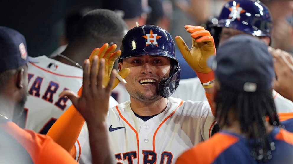 Houston Astros' Aledmys Diaz celebrates with teammates in the dugout after hitting a grand slam against the Texas Rangers during the fourth inning of a baseball game Tuesday, Aug. 9, 2022, in Houston. (AP Photo/David J. Phillip)