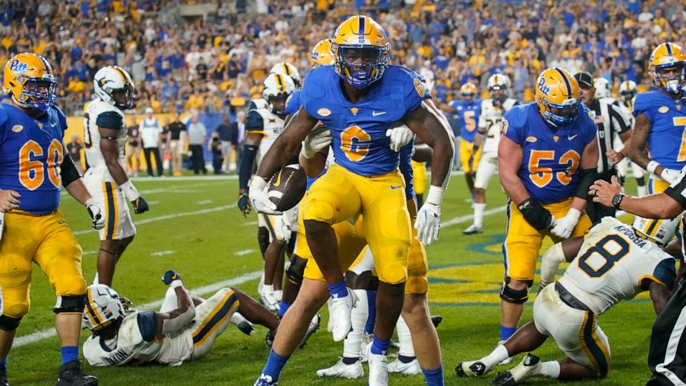 Pittsburgh running back Rodney Hammond Jr. (6) celebrates after scoring a touchdown against West Virginia during the first half of an NCAA college football game,Thursday, Sept. 1, 2022, in Pittsburgh. (AP Photo/Keith Srakocic)