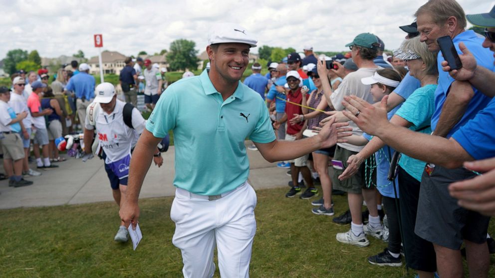 Bryson DeChambeau greets fans as he leaves the ninth hole during the second round of the 3M Open golf tournament in Blaine, Minn., Friday, July 5, 2019. (Jerry Holt/Star Tribune via AP)