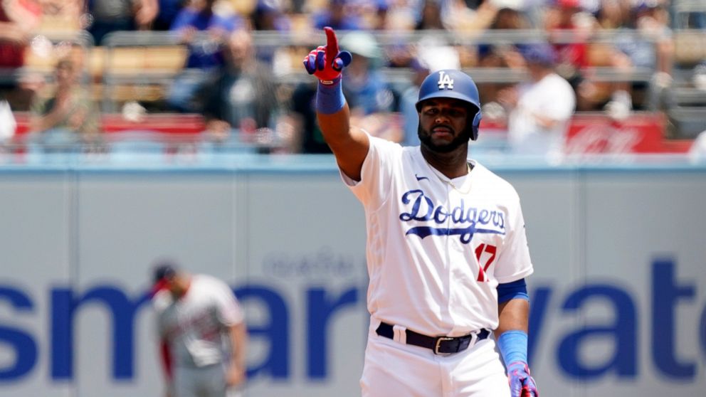 Los Angeles Dodgers' Hanser Alberto points to the dugout after driving in two runs with a double during the first inning of a baseball game against the Washington Nationals, Wednesday, July 27, 2022, in Los Angeles. (AP Photo/Marcio Jose Sanchez)
