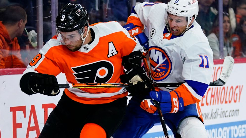 Philadelphia Flyers' Ivan Provorov, left, and New York Islanders' Zach Parise battle for position during the third period of an NHL hockey game, Sunday, March 20, 2022, in Philadelphia. (AP Photo/Matt Slocum)