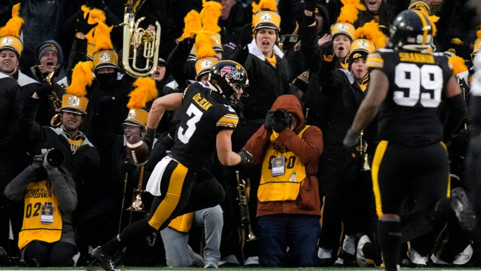 Iowa defensive back Cooper DeJean (3) celebrates after returning an interception for a touchdown during the first half of an NCAA college football game against Wisconsin, Saturday, Nov. 12, 2022, in Iowa City, Iowa. (AP Photo/Charlie Neibergall)