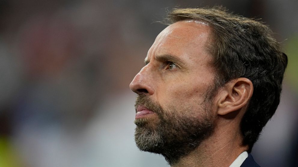 England's head coach Gareth Southgate stands during his national anthem prior to the World Cup quarterfinal soccer match between England and France, at the Al Bayt Stadium in Al Khor, Qatar, Saturday, Dec. 10, 2022. (AP Photo/Abbie Parr)