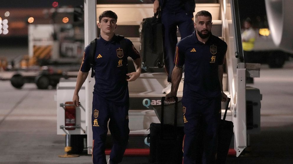 Gavi, left, and Dani Carvajal of Spain's national soccer team arrive with teammates at Hamad International airport in Doha, Qatar, Friday, Nov. 18, 2022 ahead of the upcoming World Cup. Spain will play the first match in the World Cup against Costa R