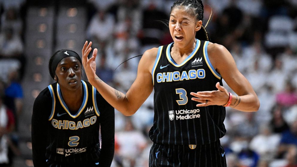 Chicago Sky forward Candace Parker, right, reacts after injuring her eye as guard Kahleah Copper, left, looks on, during Game 3 of a WNBA basketball semifinal playoff series against the Connecticut Sun, Sunday, Sept. 4, 2022, in Uncasville, Conn. (AP