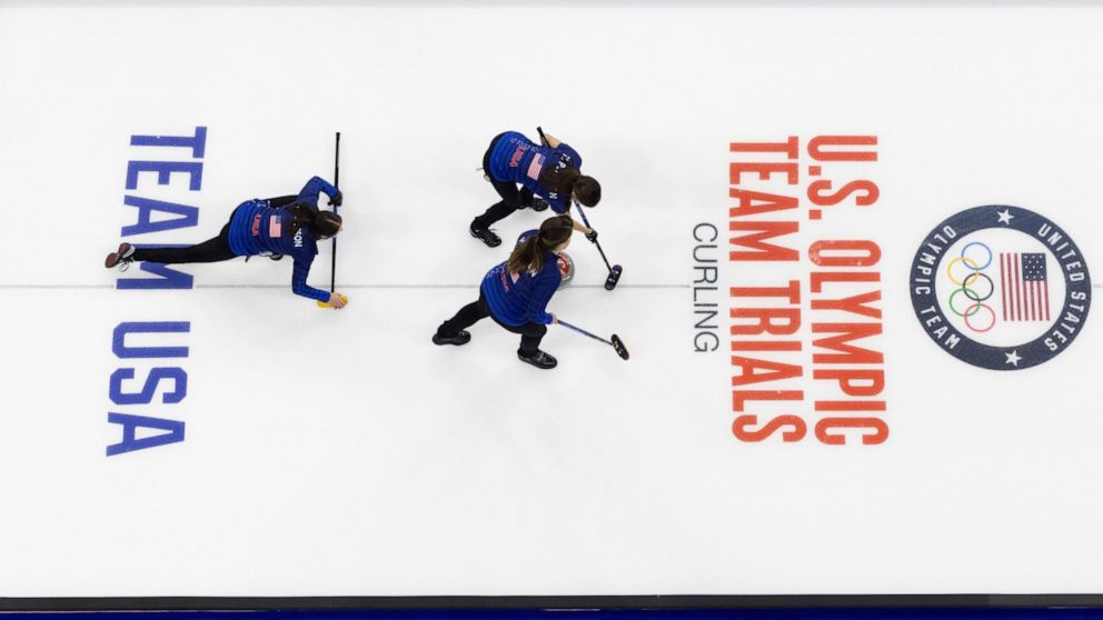 FILE — USA athletes cast the rock to sweep and curl while competing at the U.S. Olympic Curling Team Trials at Baxter Arena in Omaha, Neb., on Nov. 18, 2021. USA Curling says it's reviewing the report about the investigation into abuse and sexual mis