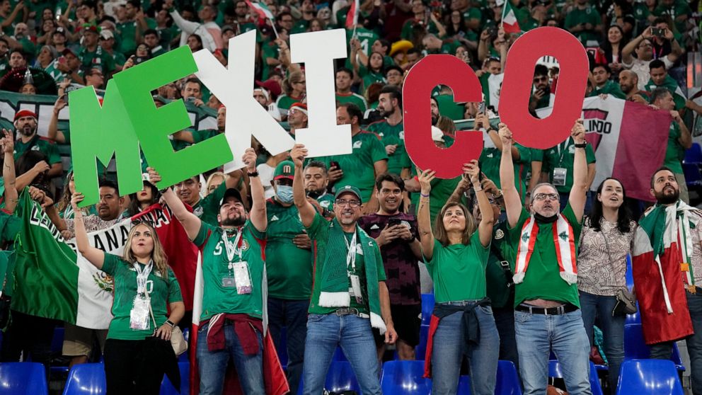 Fans of Mexico cheer during a World Cup group C soccer match against Poland at the Stadium 974 in Doha, Qatar, Tuesday, Nov. 22, 2022. (AP Photo/Martin Meissner)